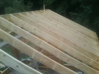 New roof rafters set over an addition before sheathing in Attleboro Falls