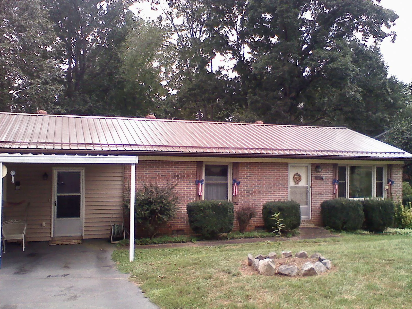 Bronze metal roof and carport on a brick ranch home — Roof Repair work by our crew in Attleboro Falls