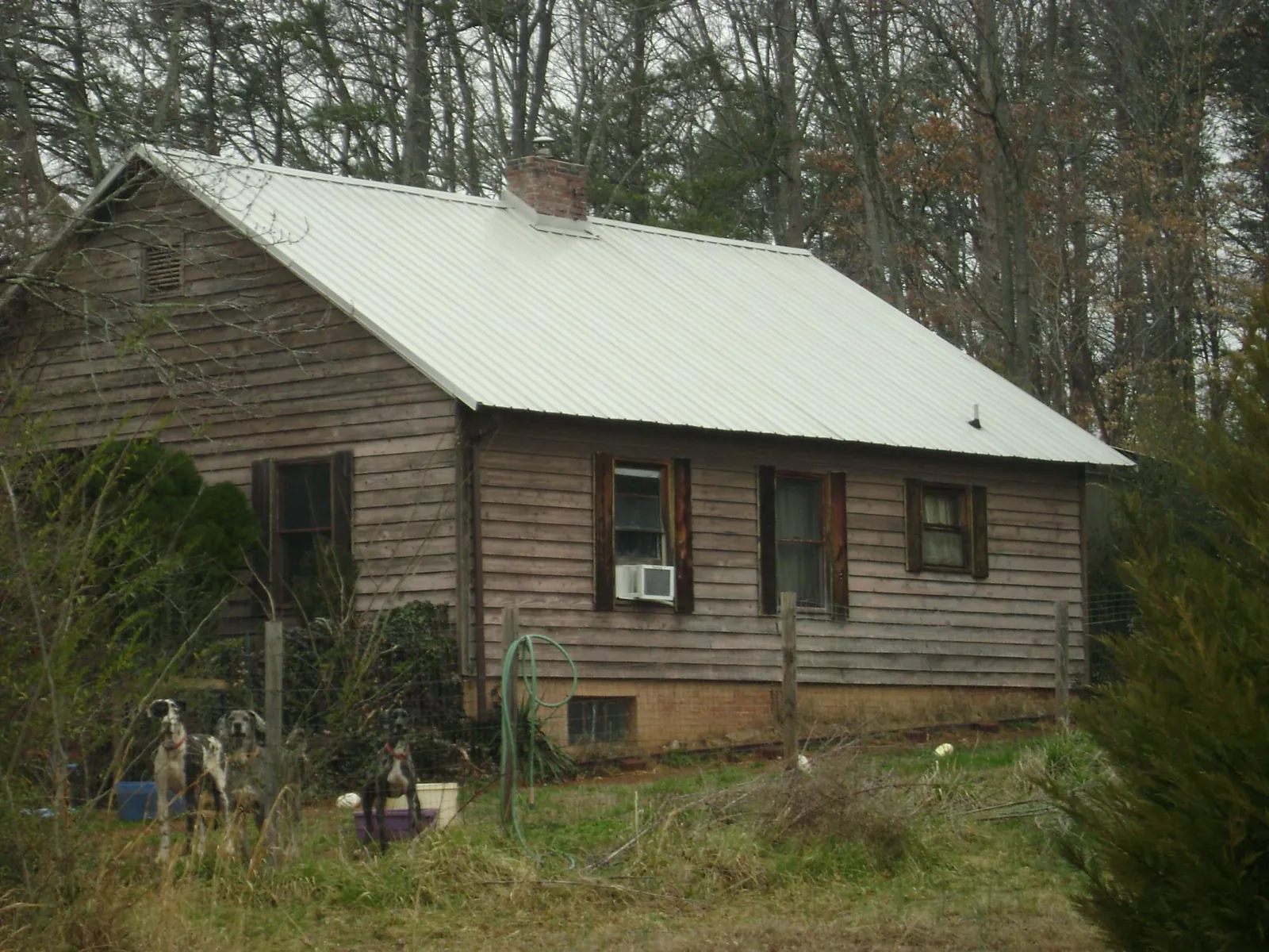 White metal roof on an old wood sided farmhouse, from a Metal Roof Installation job in Attleboro Falls